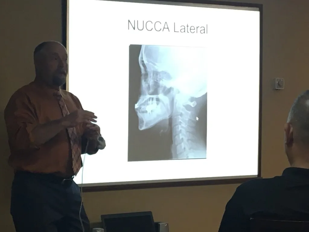 Dr. Ennis explaining a NUCCA lateral X-ray during a patient education talk
